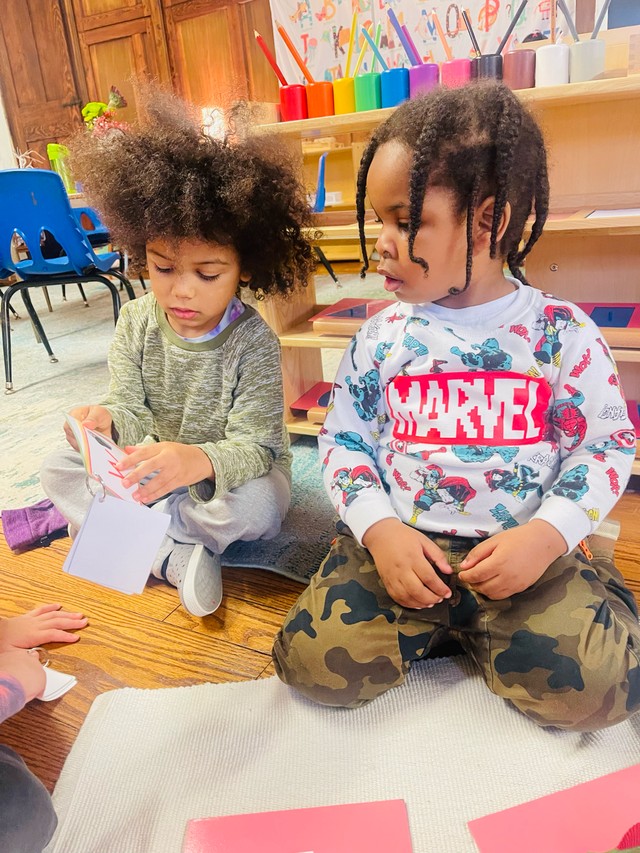 Group of children working together on collaborative art project, showcasing creativity and teamwork in Montessori environment